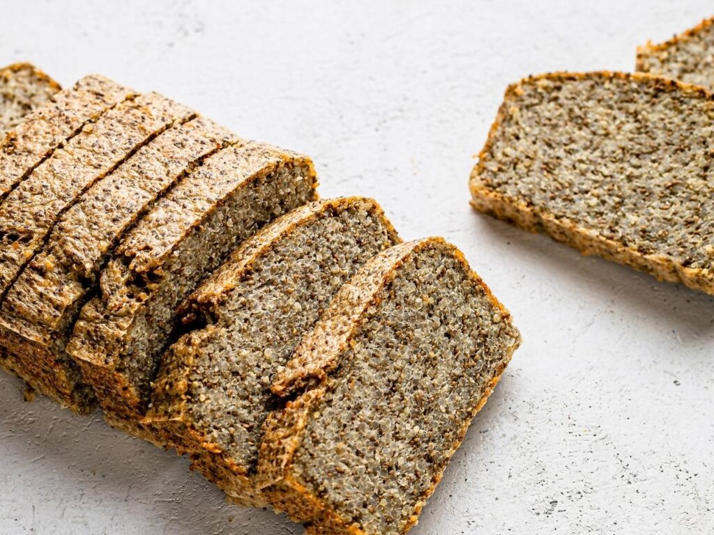 Gluten-free seed and nut loaf made with sunflower seeds, flaxseeds, chia, and psyllium husks – a fibre-rich, blood sugar-balancing alternative to refined carbs in a perimenopause diet.