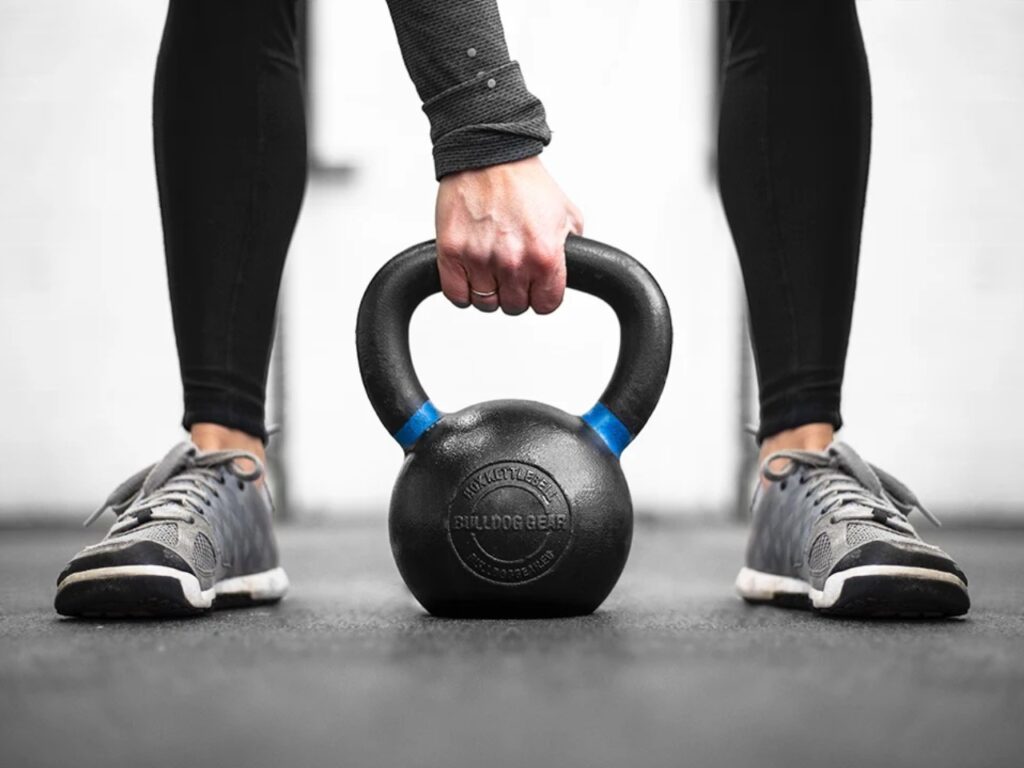 Woman lifting kettlebell during strength training workout — ideal for building strength and supporting health in midlife
