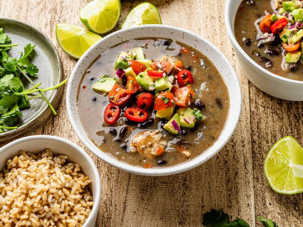 Mexican-style chilli chicken served with brown rice and avocado salsa, highlighting wholegrains for blood sugar balance and satiety in perimenopause